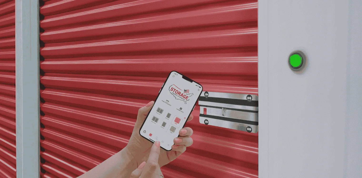 Person unlocking a red storage unit with the Storage Rentals of America app.