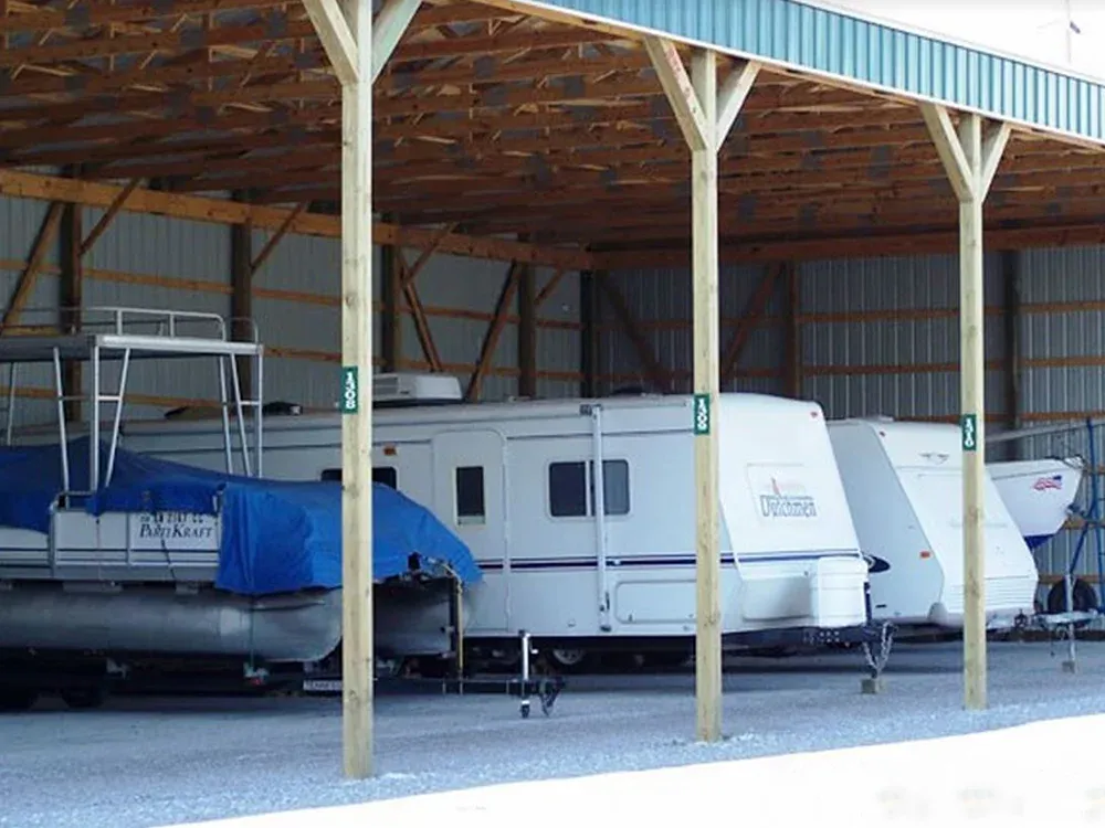 Trailers and vehicles parked under roof.