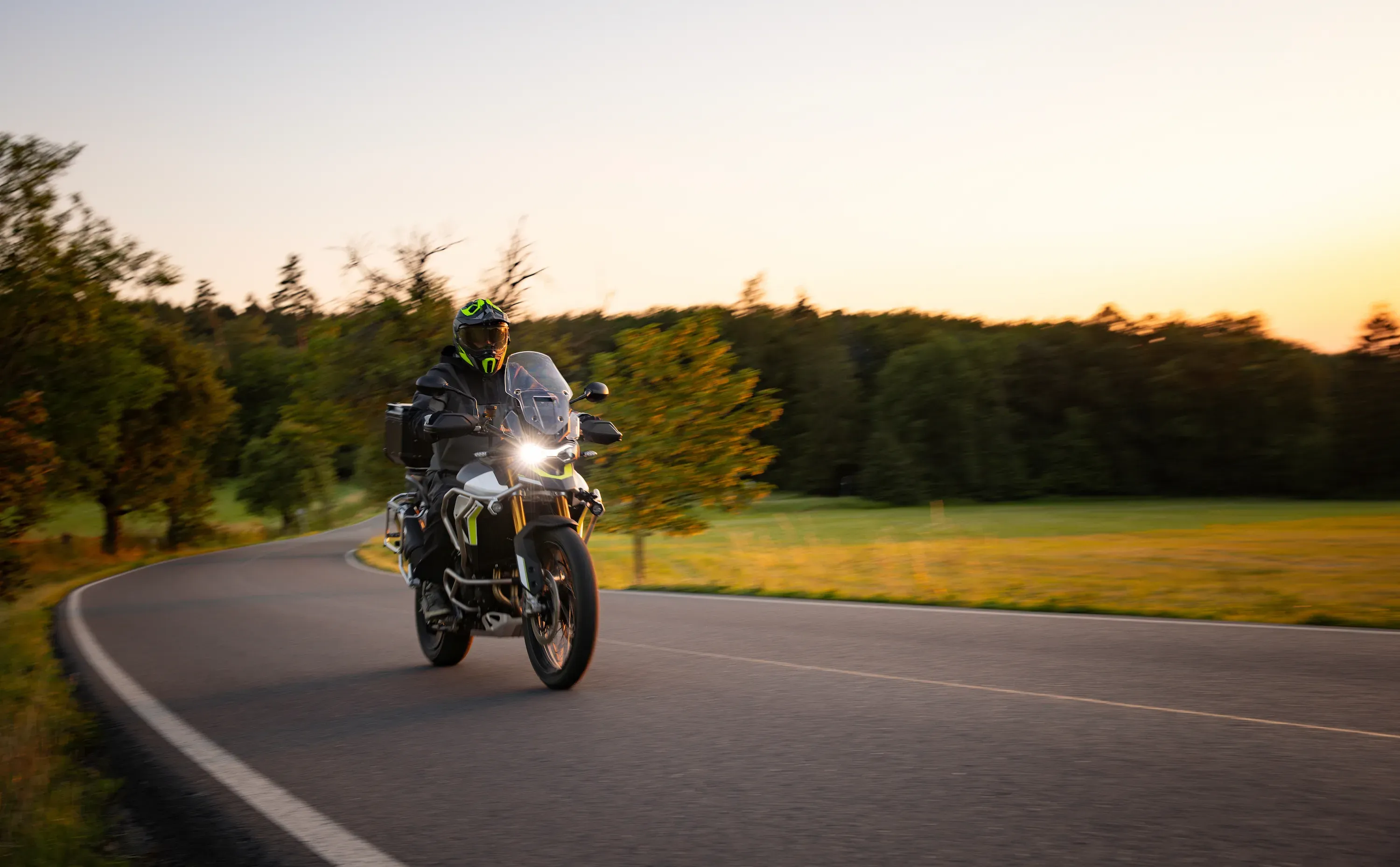 Motorcycle driving in a grassy field.