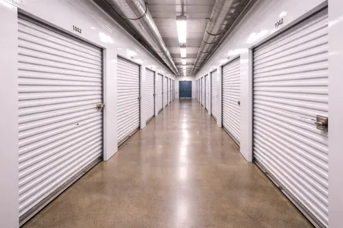 Rows of first floor storage units shown in a facility corridor.